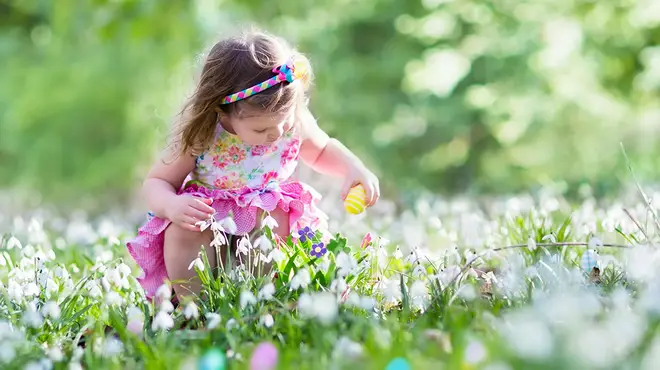 Little girl doing outdoor Easter egg hunt
