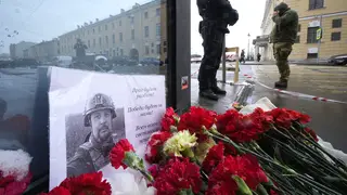 Flowers and a poster with a photo of blogger Vladlen Tatarsky