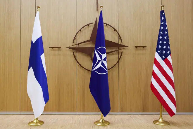A photo shows Finnish, Nato and US flags during a NATO foreign ministers' meeting at the Alliance's headquarters in Brussels