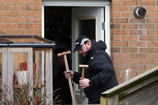 One officer was seen holding two shovels as police searched the back garden