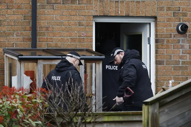Police searching the couple's back garden yesterday