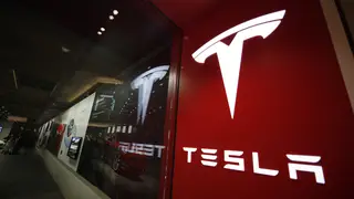 A sign bearing the Tesla company logo