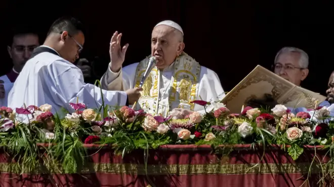 Pope Francis bestows the plenary Urbi et Orbi (to the city and to the world) blessing from the central lodge of St Peter’s Basilica at the Vatican at the end of the Easter Sunday Mass