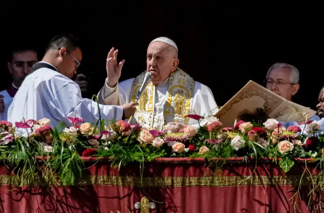 Pope Francis bestows the plenary 'Urbi et Orbi' (to the city and to the world) blessing from the central lodge of the St. Peter's Basilica at The Vatican at the end of the Easter Sunday mass