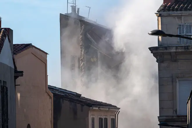 Smoke rises after the collapse of a building at 17 rue de Tivoli