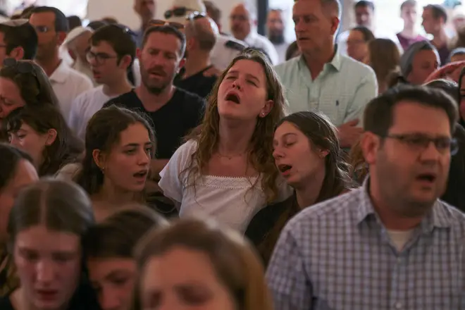 Mourners reportedly sang songs of grief during the service
