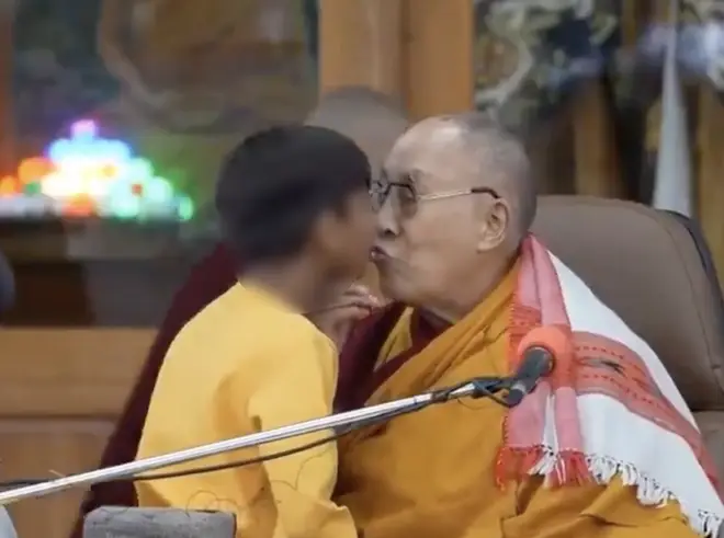 The Dalai Lama kissing the boy