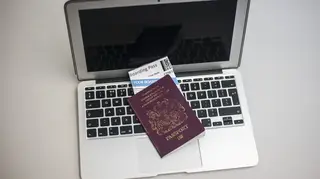 Laptop, passport and travel ticket