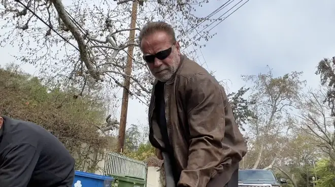 "Arnie" can be seen getting his hands dirty fixing the pothole in garb reminiscent of his role as The Terminator