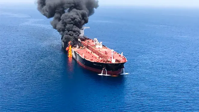 Fire and smoke seen billowing from an oil tanker believed to have been attacked in the water of the Gulf of Oman.