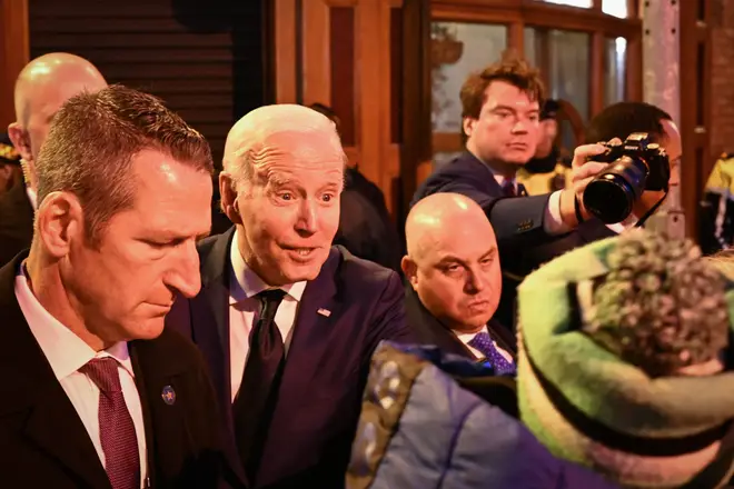 US President Joe Biden greets members of the public as he leaves the Windsor Bar in Dundalk