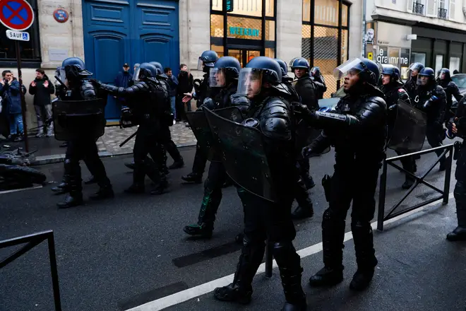 Gendarmes in riot gear stand guard during a demonstration