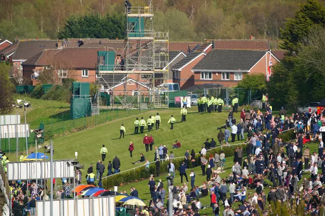 Police officers respond to Animal Rising activists attempting to invade the race course ahead of the Randox Grand National Handicap Chase