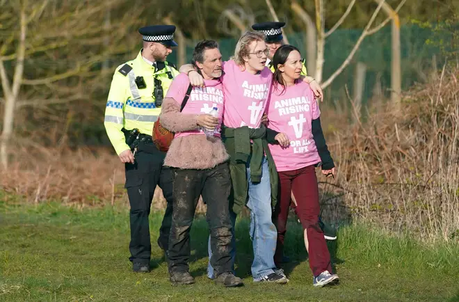 Protesters being detained by police at the race on Saturday