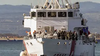 An Italian coast guard ship brings some 300 migrants in to Catania, Sicily