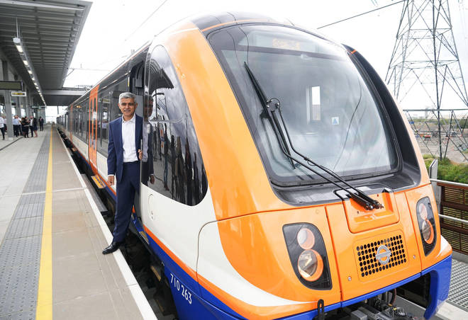 Sadiq Khan poses with a London Overground train, during the official celebration of the opening of the new Barking Riverside station, in Barking, east London.