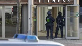 Armed police officers in front of a health club in Duisburg, Germany