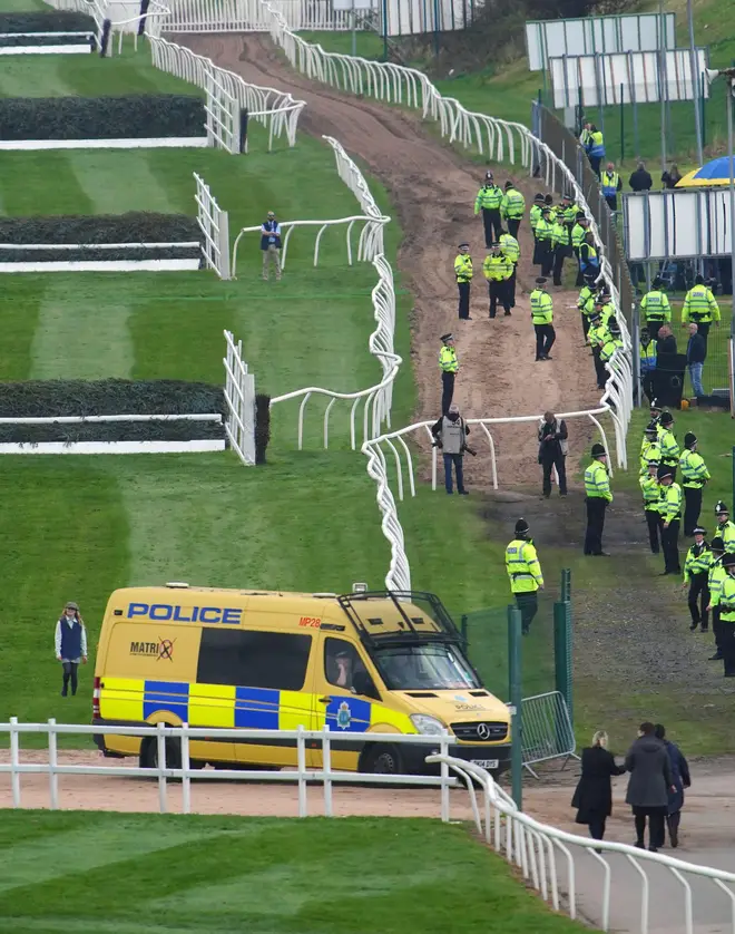 Police at the Grand National where protesters disrupted the start of the event