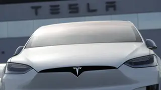 A 2018 Model X 100d sits on a Tesla dealer’s lot