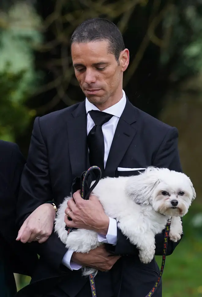 Andre carried the pair's dog throughout the funeral procession.