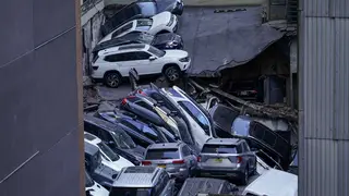 Cars are seen piled on top of each other at the collapsed parking garage (Mary Altaffer/AP)