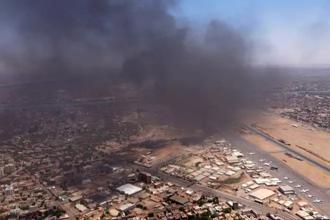 black smoke rising above the Khartoum International Airport on April 20, 2023, amid ongoing battles between the forces of two rival generals.