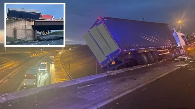A lorry was left hanging precariously off a bridge above the A14 after the HGV crashed into a barrier on the M1 in Leicestershire.