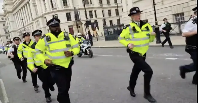 The officers were filmed jogging alongside the motorcade