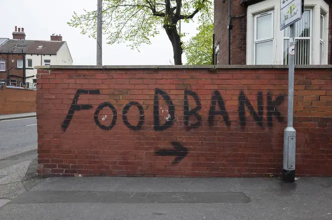 Graffiti pointing towards a local food bank in Harehills, Leeds, May 2022.