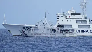 A Chinese coastguard ship blocks Philippine coastguard boat BRP Malapascua