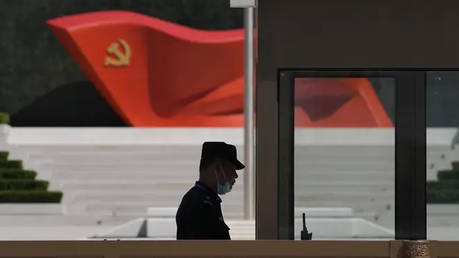 A security guard stands near a sculpture of the Chinese Communist Party flag at the Museum of the Communist Party of China in Beijing