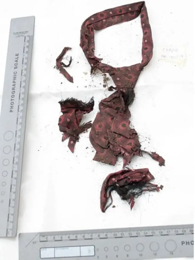 The remains of his clothes including his tie point to the 1960s