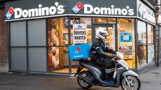 A Domino’s store and delivery rider