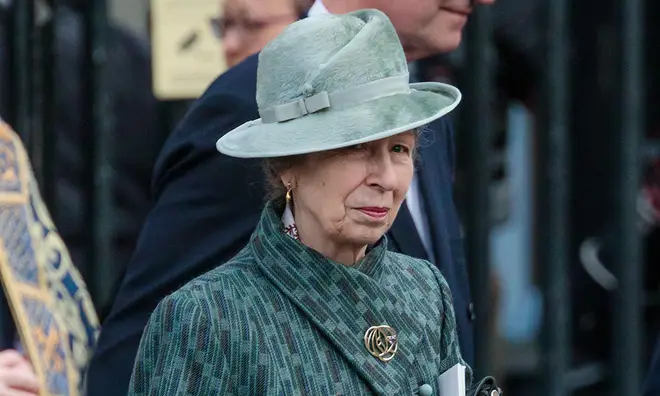 Princess Anne wearing a green hat with matching coat and silver broach