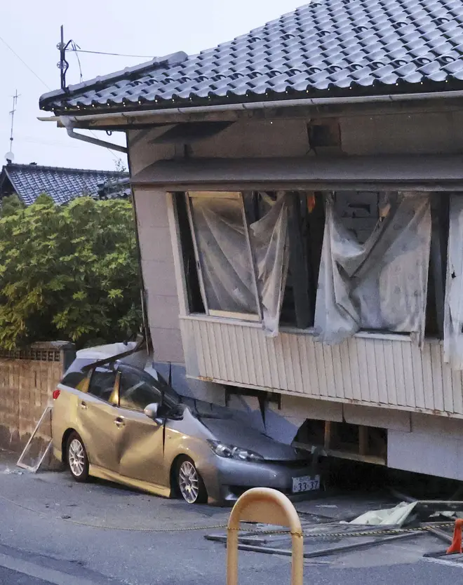Car crushed by a house