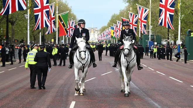 Police horses patrol the Mall ahead of the King's Coronation
