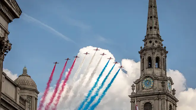 The Red Arrows emitting red, white and blue smoke over London