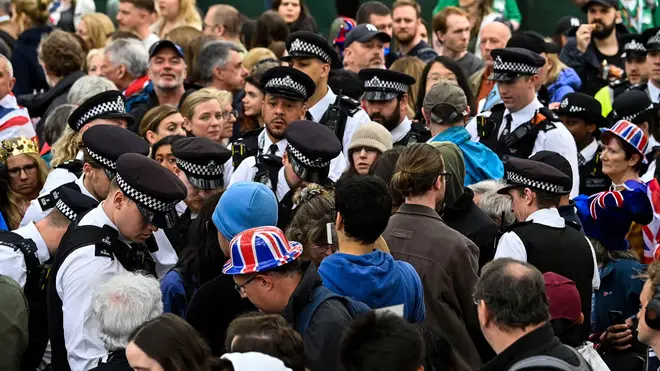 A Just Stop Oil protester was carried out of the crowd after a police search