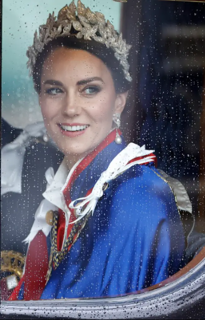 Kate smiles during the procession back from Buckingham Palace