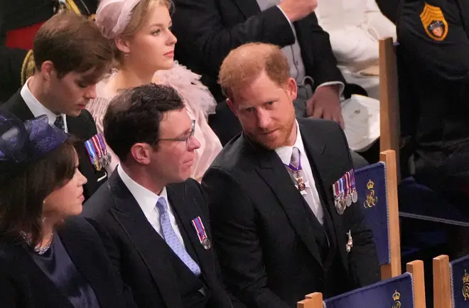 Harry (R) was sat next to his cousin Princess Eugenie (L) and her husband Jack Brooksbank (C) at the ceremony
