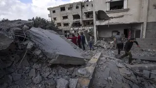 Palestinians inspect the rubble at the site of an air strike that the Israeli military said targeted the house of an Islamic Jihad member, in Deir al-Balah, central Gaza Strip