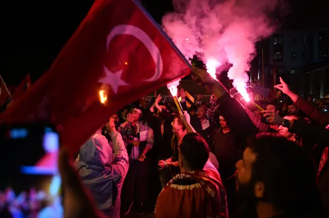 Erdogan supporters light flares as they celebrate in front of the Justice and development Party (AKP's) headquarters after polls closed