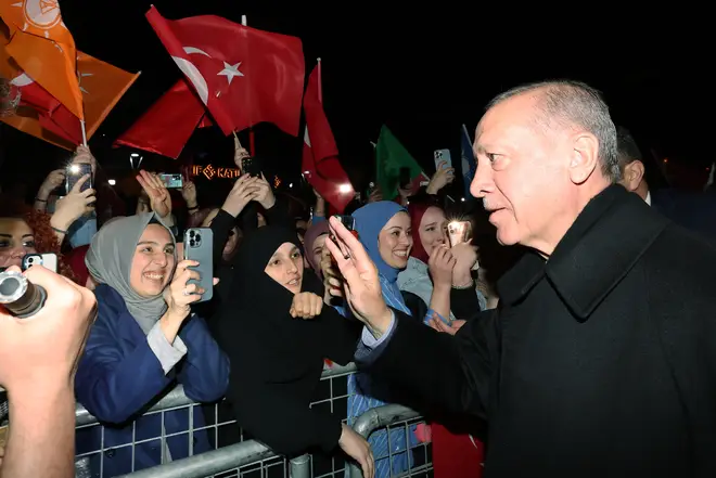 Erdogan greets the crowd outside his residence