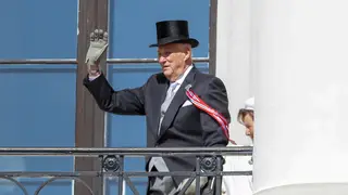 Norway’s King Harald V waves from the balcony at Skaugum, his official residence, on Constitution Day 2023