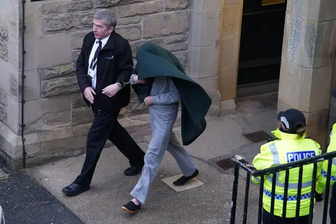 Andrew Miller (covered) being led from Selkirk Sheriff Court following an earlier hearing.