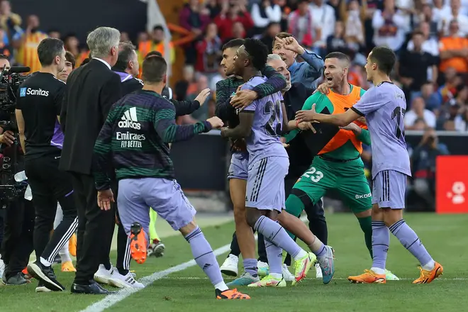 Real Madrid's Vinicius Junior, center, leaves the pitch after being shown a red card