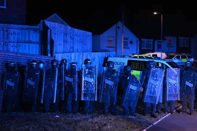 Riot police form a line near Snowden Road, Ely