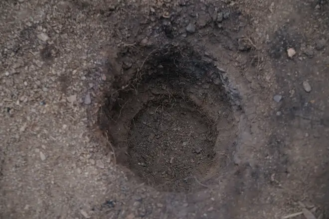A hole dug apparently for soil samples in the area around Barragem do Arade reservoir, in the Algave
