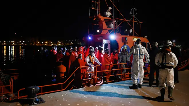 Migrants rescued from a dinghy at the Mediterranean Sea
