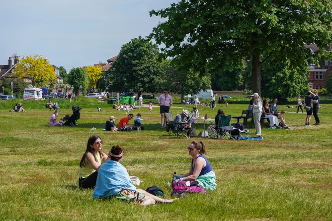 People enjoying the sun on Wimbledon Common, south west London on bank holiday Sunday